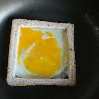 然后拿出之前切好的面包框，打一个鸡蛋进去，搅一下ヽ(^0^)ﾉ