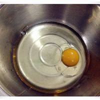 将鸡蛋和油倒进盆里（可以选一个大点的鸡蛋，预留一点鸡蛋液用于后面刷表面）；