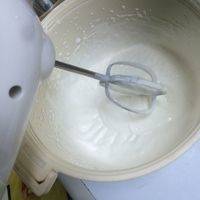 用打蛋器将淡奶油打发至能够拉起小尖角。
