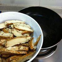 热锅加油，将豆干改刀下锅炒制。