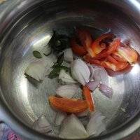 Put curry leaves, green chili, tomato and onions into a pressure cooker